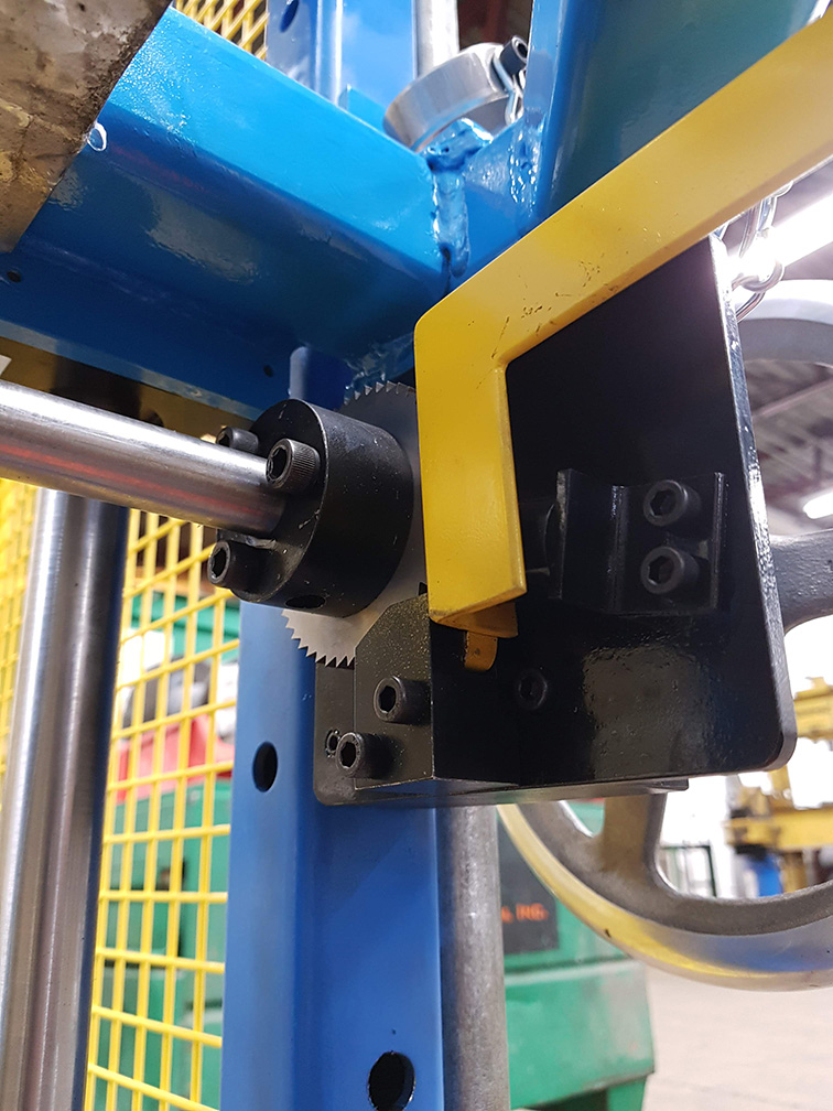closeup with yellow and blue equipment and steel tubing