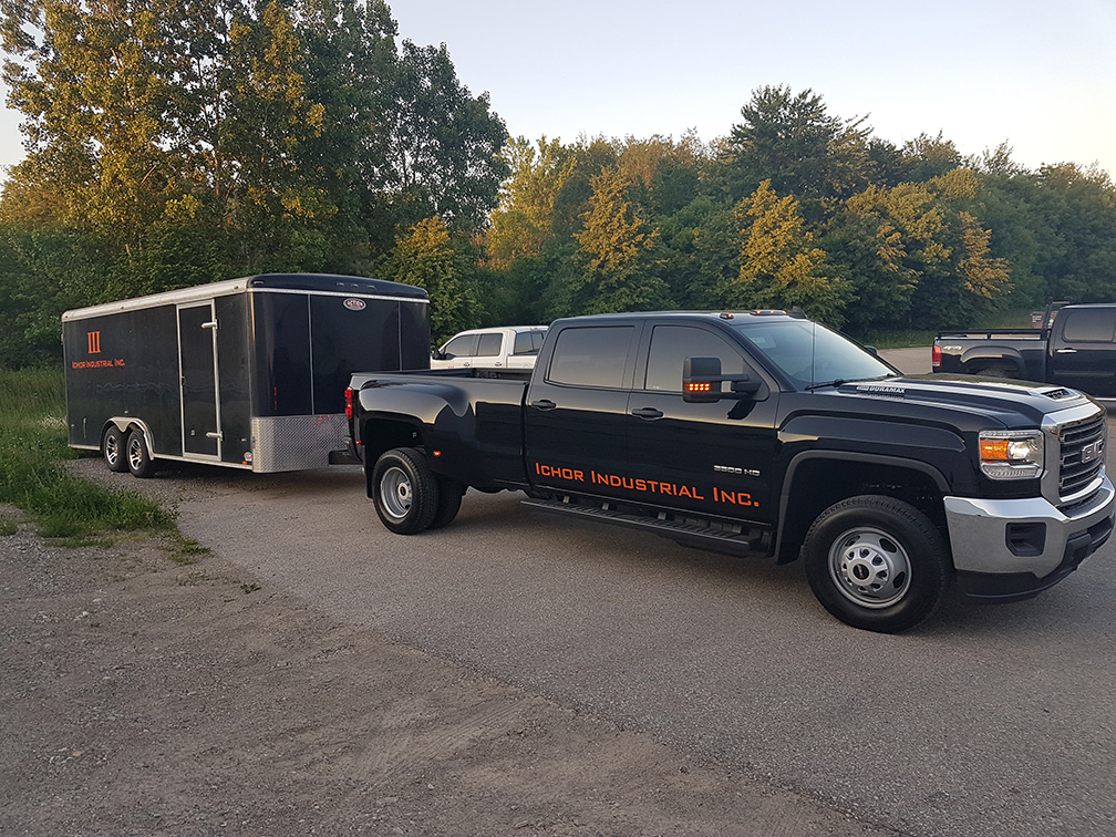 black truck ichor industrial with trailer