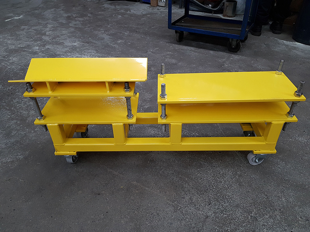 yellow wheeled stand with bolts and screws