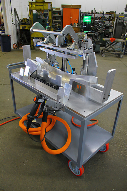 silver machine with orange tubing